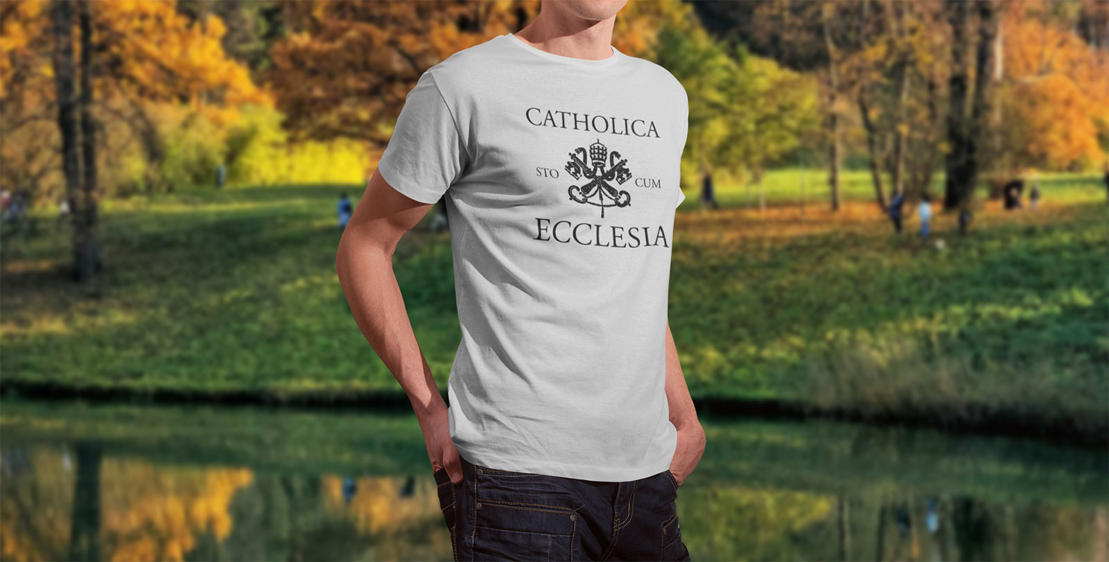 Man wearing a Solemnitees t-shirt and standing in front of lake.