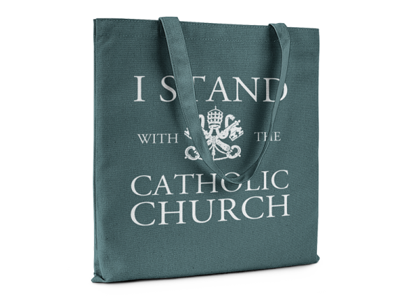 Green tote bag that reads I Stand With The Catholic Church.