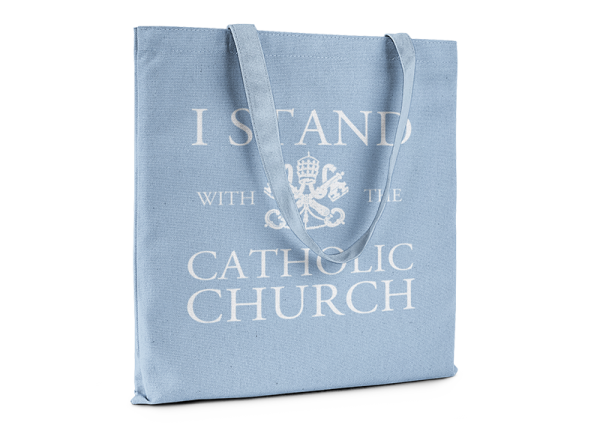 Light blue tote bag that reads I Stand With The Catholic Church.