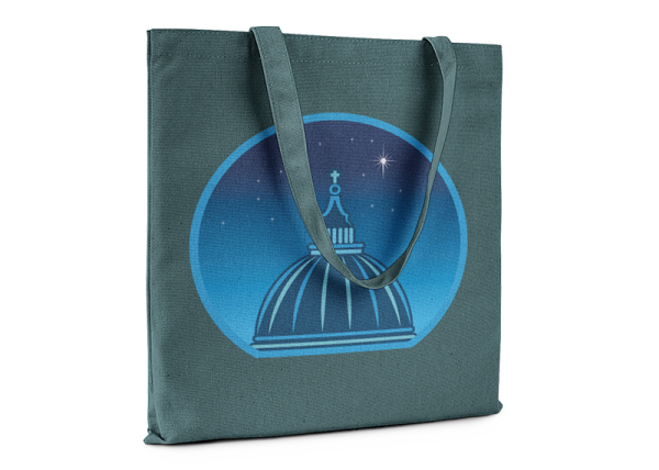Green tote bag printed with a graphic of a cathedral cupola against a starry night sky.