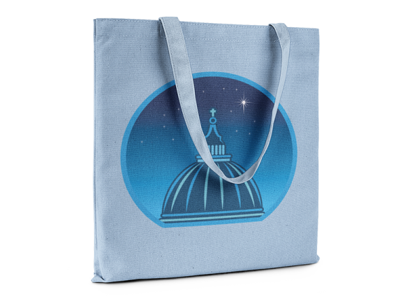 Light blue tote bag printed with a graphic of a cathedral cupola against a starry night sky.