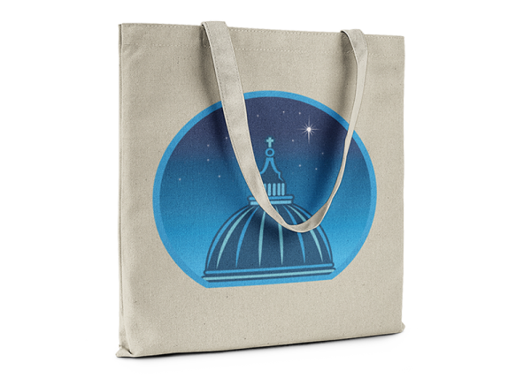 Natural color tote bag printed with a graphic of a cathedral cupola against a starry night sky.