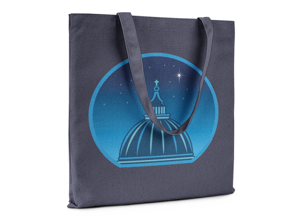 Navy blue tote bag printed with a graphic of a cathedral cupola against a starry night sky.